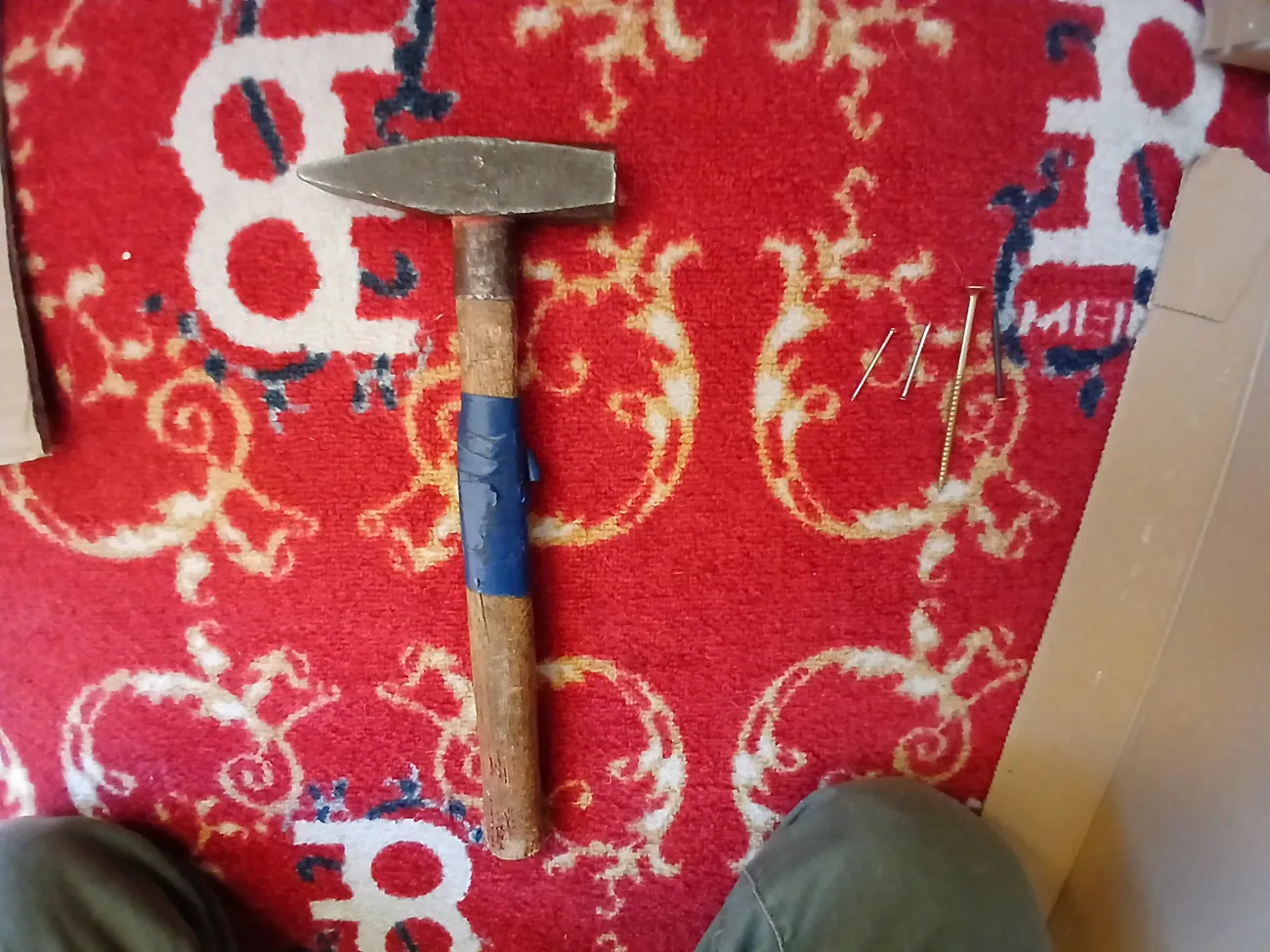 Foley props laid out for a recording session: a hammer, nails and screws