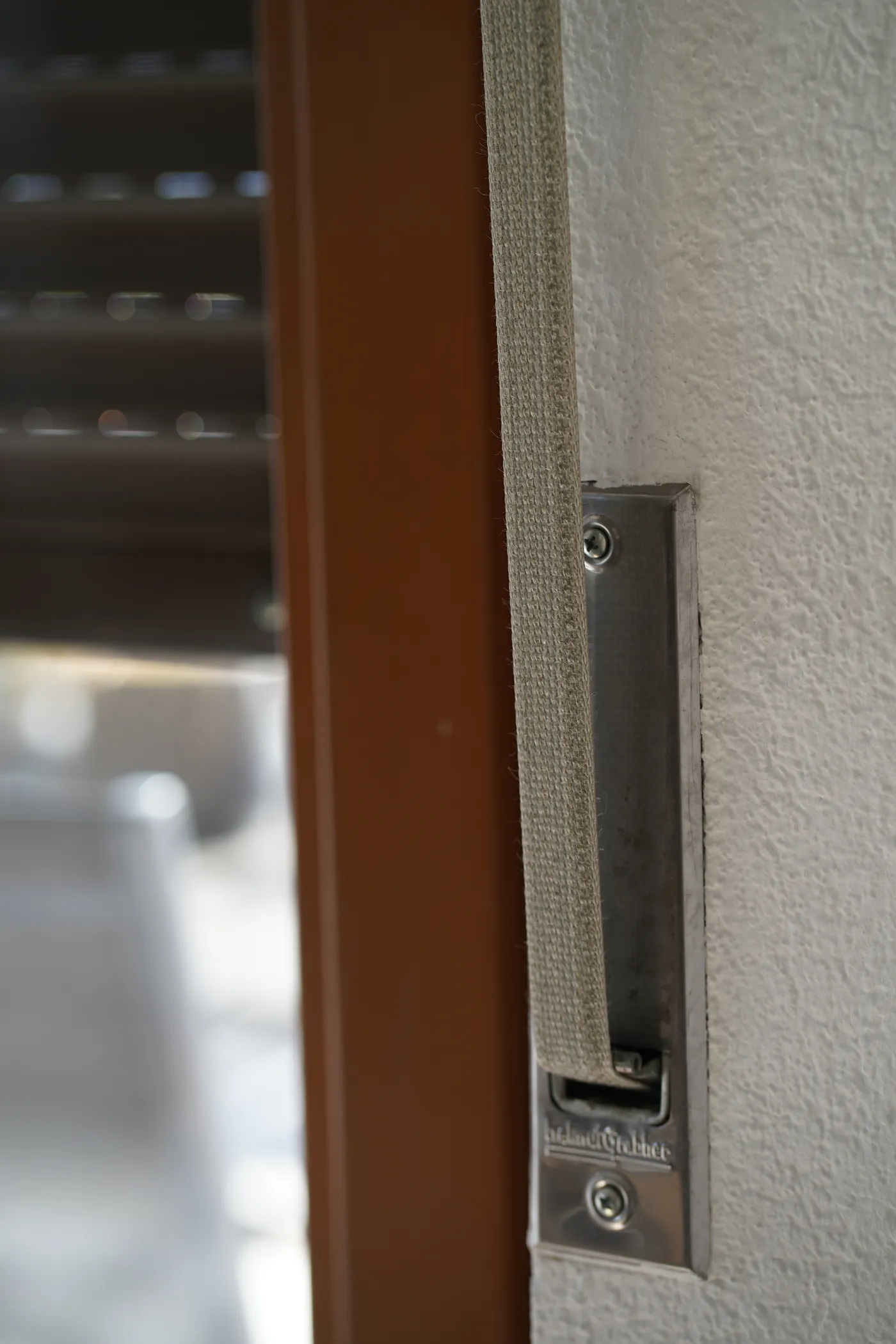 The guide rail of a roller shutter at the side of a window