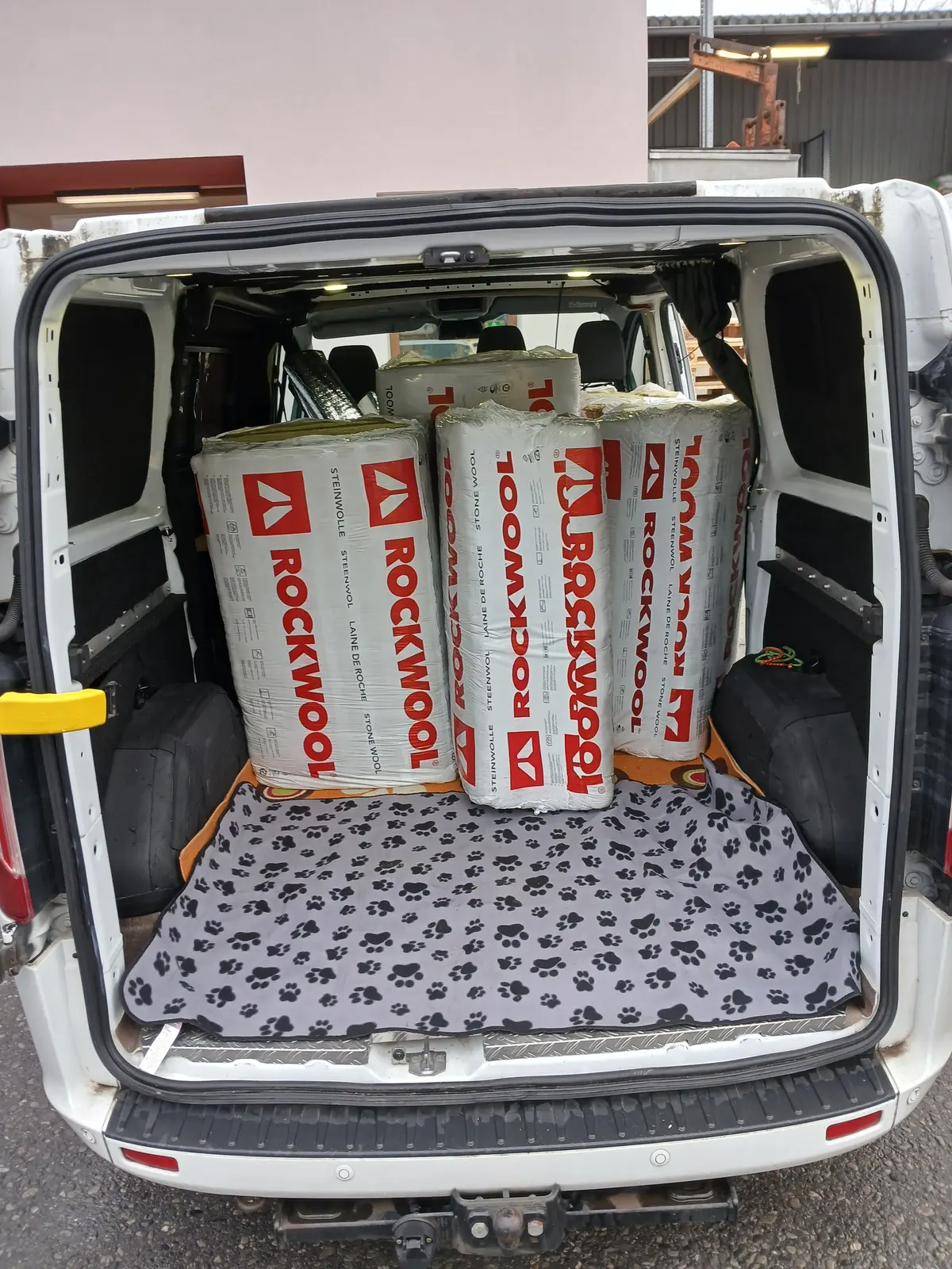 Rolls of Rockwool stone wool insulation stacked in the back of a van